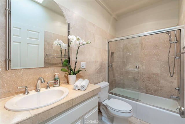 14919 Dickens St Unit 104, Sherman Oaks, CA 91403 - full bath with vanity, combined bath / shower with glass door, tile walls, and decorative backsplash