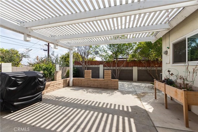 view of patio / terrace with a pergola, grilling area, and fence