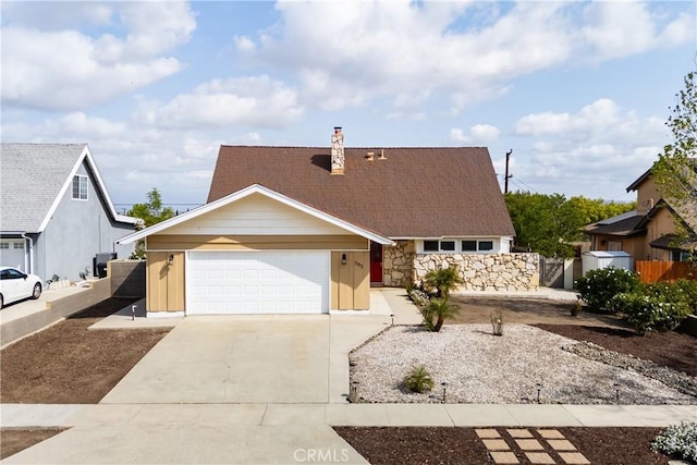 view of front of property with fence, driveway, a garage, and a chimney