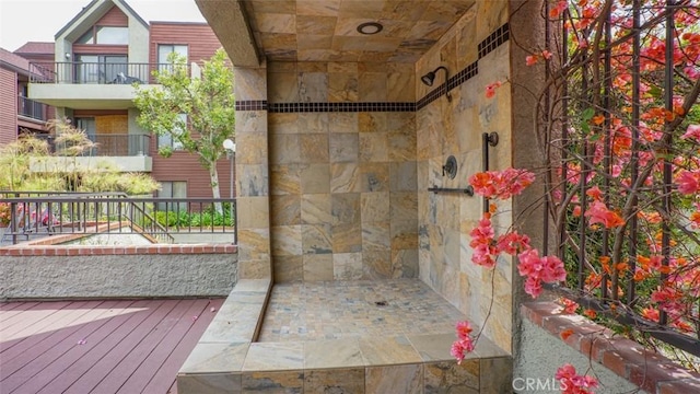 bathroom featuring hardwood / wood-style flooring and tiled shower