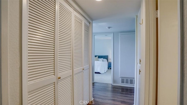 hall with visible vents and dark wood-type flooring