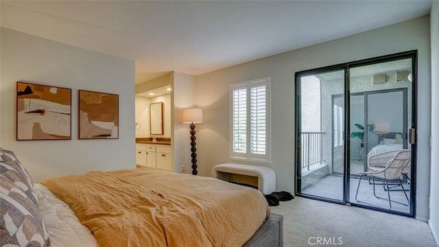 bedroom with carpet flooring, ensuite bath, and access to exterior