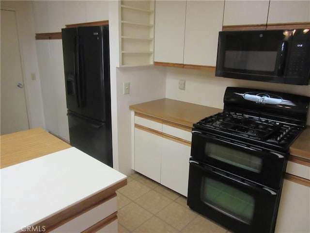kitchen featuring white cabinets, light tile patterned floors, black appliances, and open shelves