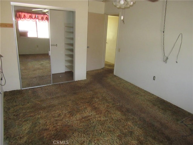 unfurnished bedroom featuring carpet flooring and a closet