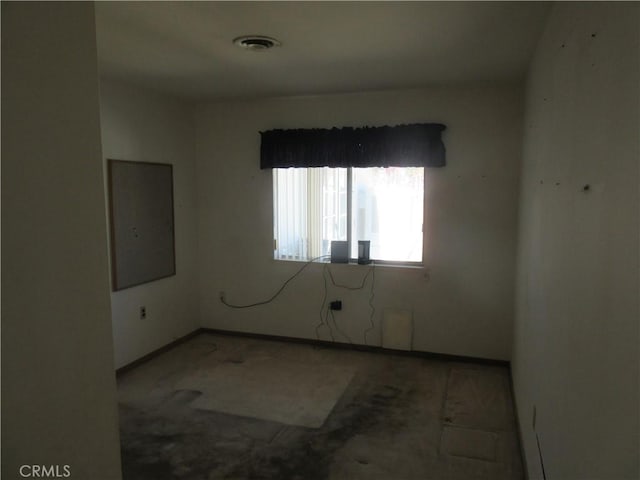 unfurnished room with visible vents