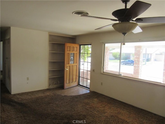 interior space featuring carpet floors, visible vents, and a ceiling fan