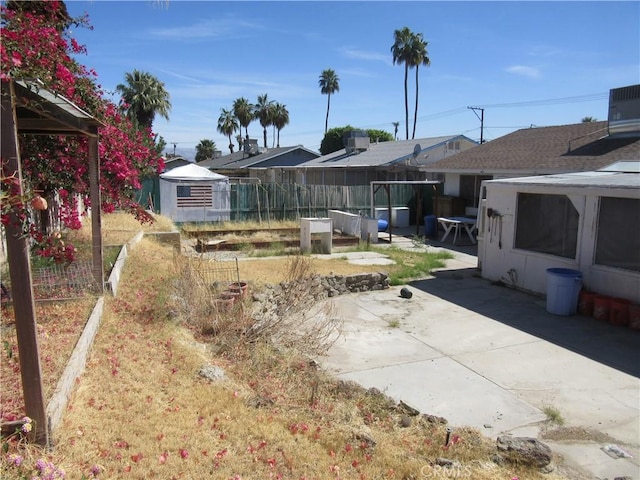 view of yard with fence and a patio area