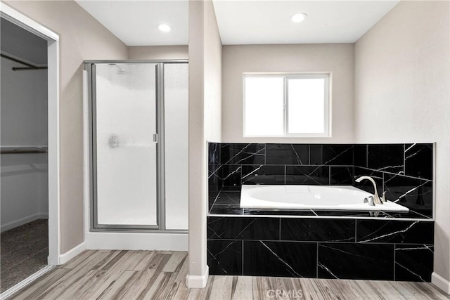 18420 Wisteria St, Hesperia, CA 92345 - bathroom with a stall shower, baseboards, a garden tub, and wood finished floors