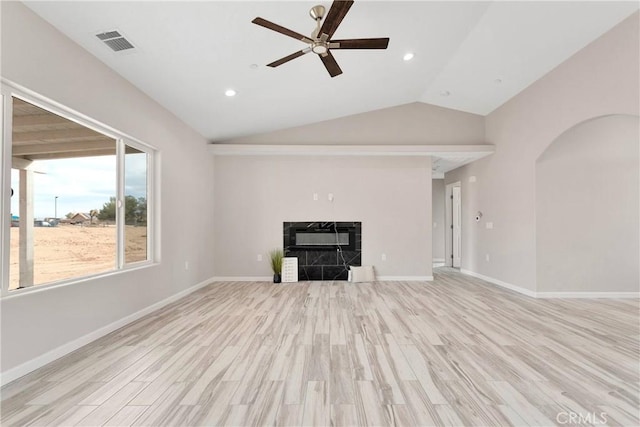 18420 Wisteria St, Hesperia, CA 92345 - unfurnished living room featuring arched walkways, ceiling fan, light wood-style flooring, visible vents, and a fireplace