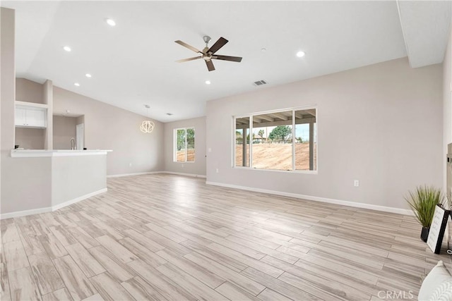 18420 Wisteria St, Hesperia, CA 92345 - unfurnished living room with lofted ceiling, light wood-type flooring, baseboards, visible vents, and ceiling fan