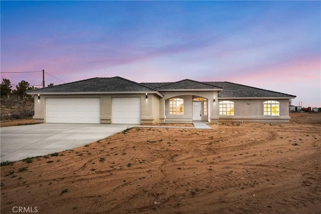 18420 Wisteria St, Hesperia, CA 92345 - view of front of home with stucco siding, an attached garage, and concrete driveway