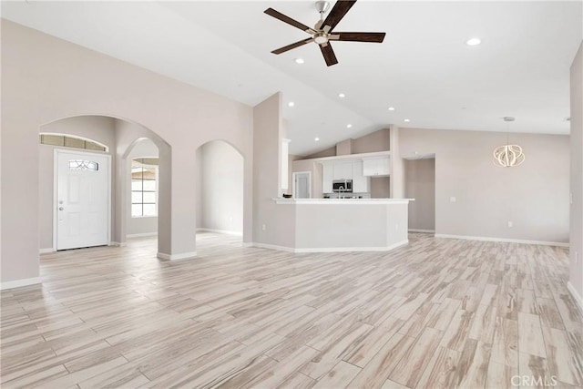 18420 Wisteria St, Hesperia, CA 92345 - unfurnished living room featuring baseboards, recessed lighting, a ceiling fan, arched walkways, and light wood-type flooring