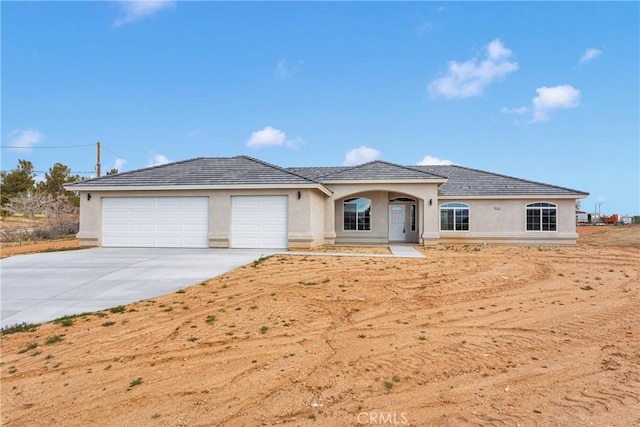 18420 Wisteria St, Hesperia, CA 92345 - view of front of house featuring stucco siding, driveway, a garage, and a tile roof