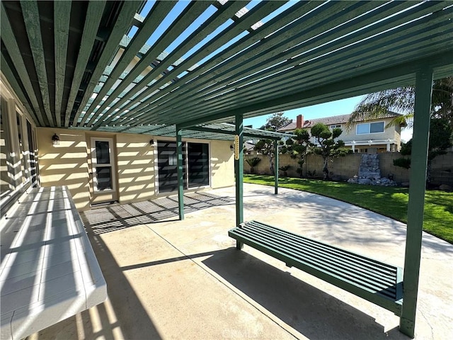 view of patio featuring a pergola and fence