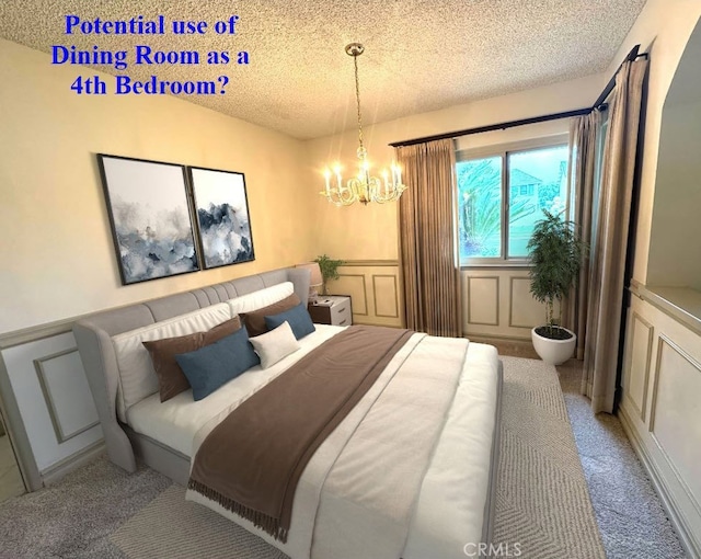 3118 N Hartman St, Orange, CA 92865 - bedroom with light carpet, a textured ceiling, a decorative wall, wainscoting, and a chandelier