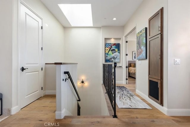2865 Rock Wren Ln, Avila Beach, CA 93424 - corridor with an upstairs landing, a skylight, light wood-style floors, and recessed lighting