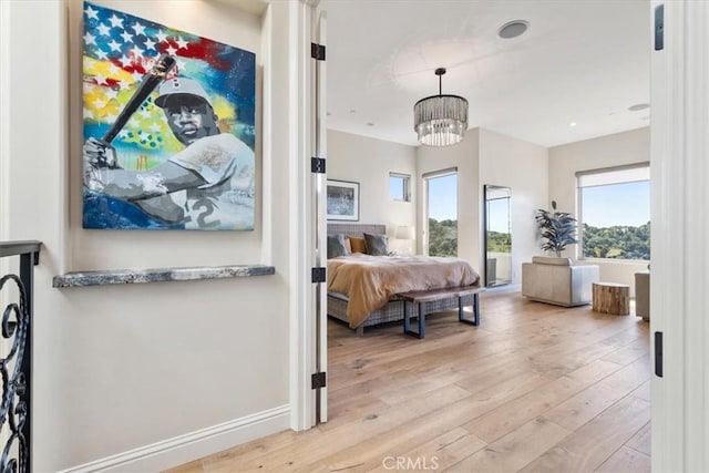 2865 Rock Wren Ln, Avila Beach, CA 93424 - bedroom with light wood finished floors and a chandelier