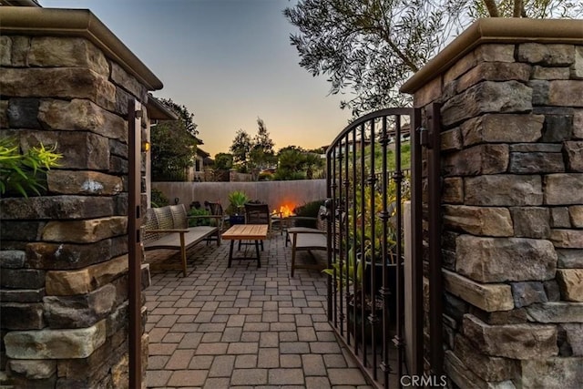 2865 Rock Wren Ln, Avila Beach, CA 93424 - patio terrace at dusk with a gate, a patio, and an outdoor hangout area