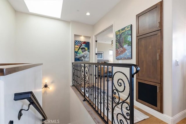 2865 Rock Wren Ln, Avila Beach, CA 93424 - hall featuring an upstairs landing, a skylight, wood finished floors, recessed lighting, and baseboards