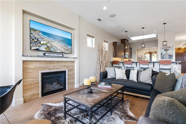 2865 Rock Wren Ln, Avila Beach, CA 93424 - living area featuring light wood-style floors, recessed lighting, a tile fireplace, and plenty of natural light