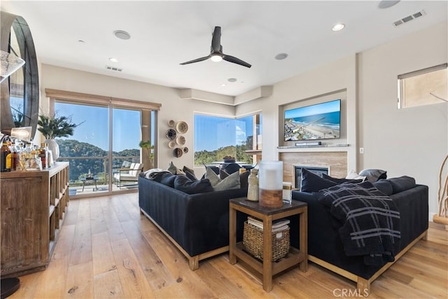 2865 Rock Wren Ln, Avila Beach, CA 93424 - living area with a ceiling fan, light wood-style flooring, a glass covered fireplace, and recessed lighting