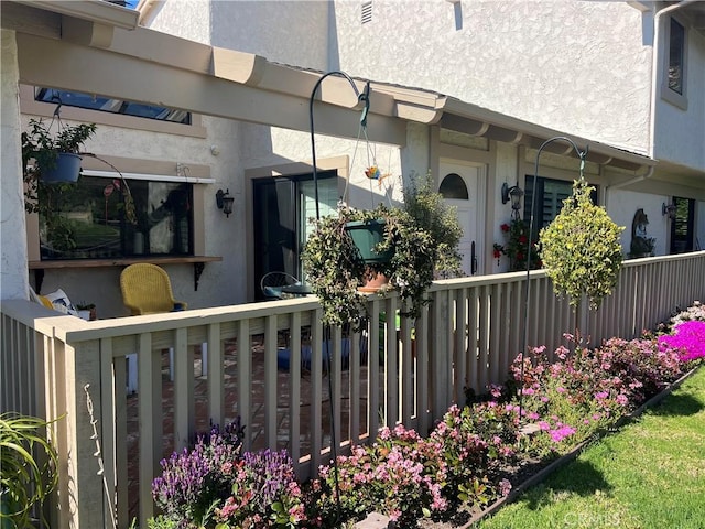 exterior space featuring fence and stucco siding