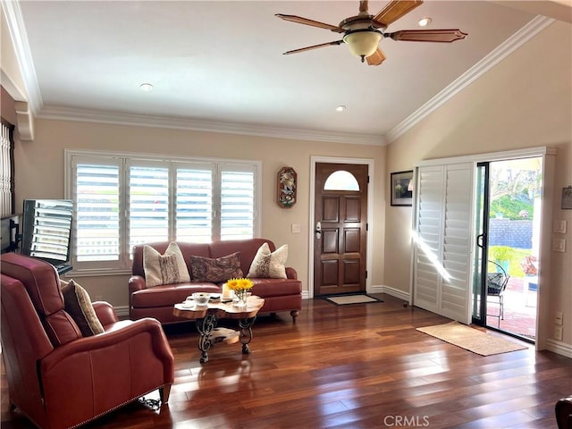 living room featuring baseboards, wood finished floors, ceiling fan, and crown molding