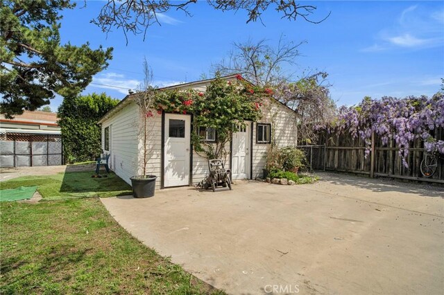 exterior space featuring an outbuilding and fence