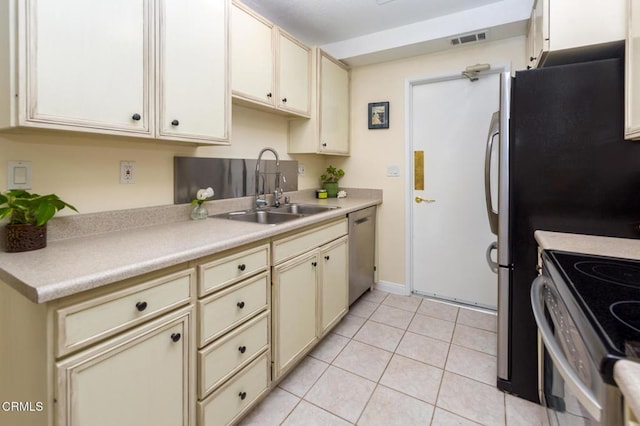 15413 Village 15, Camarillo, CA 93012 - kitchen with stainless steel appliances, cream cabinets, a sink, light tile patterned flooring, and visible vents