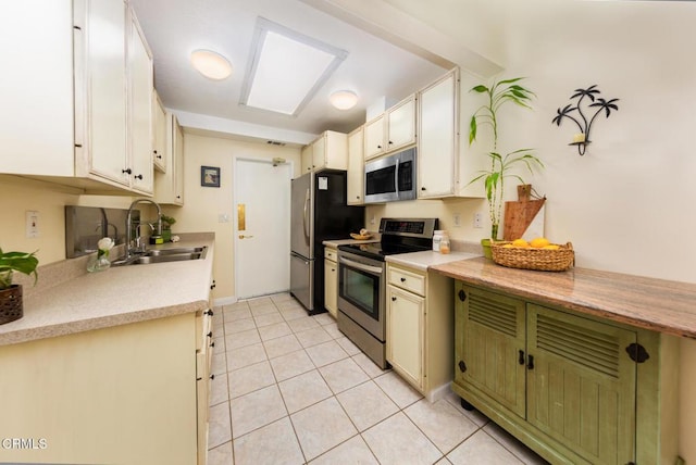 15413 Village 15, Camarillo, CA 93012 - kitchen with light tile patterned flooring, light countertops, a sink, and appliances with stainless steel finishes