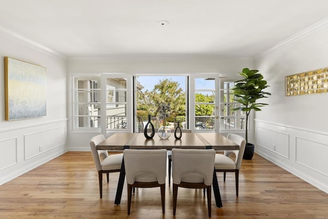 1451 Savoy Cir, San Diego, CA 92107 - dining room with healthy amount of natural light, crown molding, light wood-type flooring, a decorative wall, and a wainscoted wall
