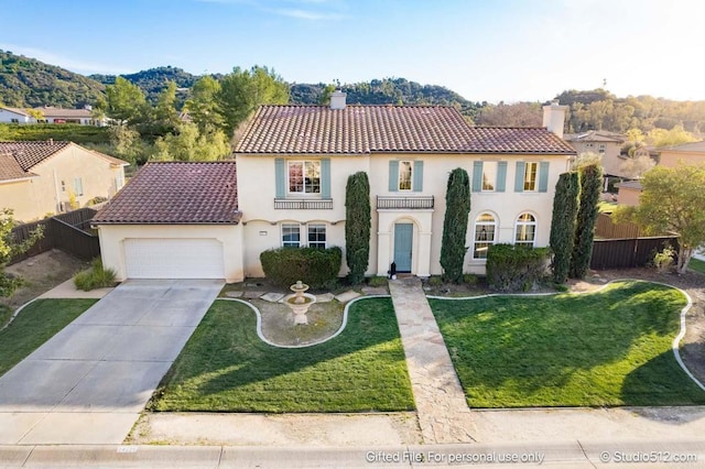 mediterranean / spanish home with a tiled roof, a chimney, fence, an attached garage, and stucco siding