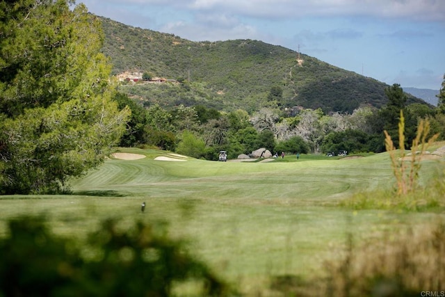surrounding community with view of golf course and a mountain view