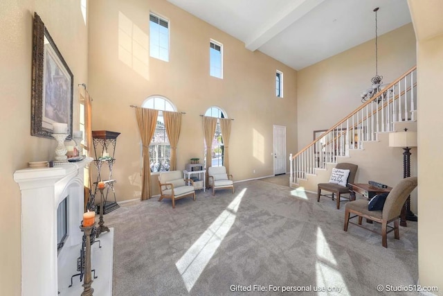 carpeted living room with a high ceiling, stairs, beamed ceiling, and baseboards