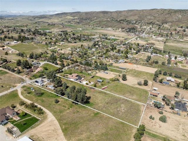 drone / aerial view featuring a residential view and a mountain view