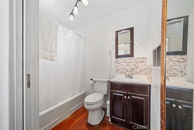 bathroom with backsplash, wood finished floors, vanity, toilet, and shower / bathtub combination with curtain