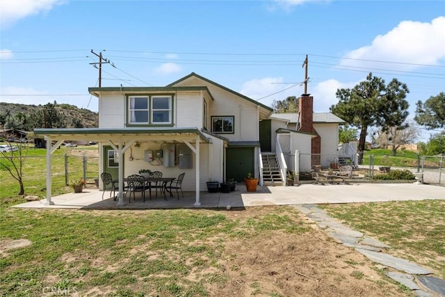 rear view of house featuring a patio, a yard, and fence private yard