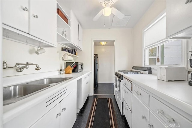 kitchen featuring open shelves, a sink, light countertops, white gas range, and a ceiling fan