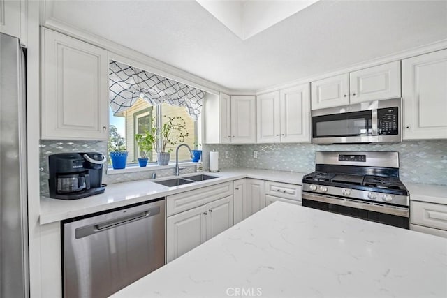 kitchen with a sink, backsplash, and stainless steel appliances