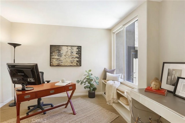 office space featuring baseboards and light colored carpet