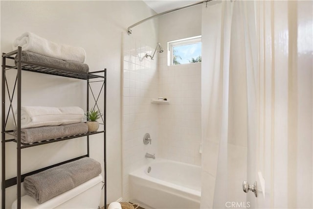full bathroom with shower / bath combo with shower curtain and toilet