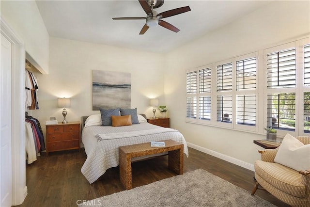 bedroom featuring a ceiling fan, baseboards, and wood finished floors