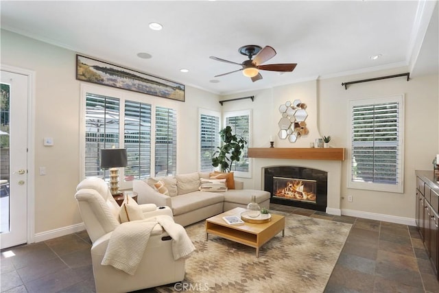 living room with ceiling fan, a healthy amount of sunlight, and crown molding