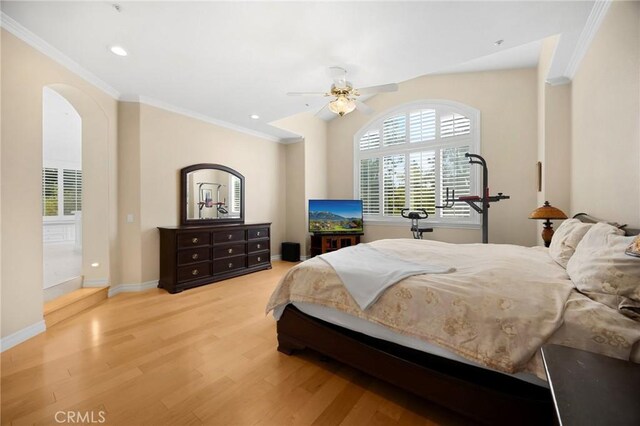 bedroom with crown molding, multiple windows, and wood finished floors