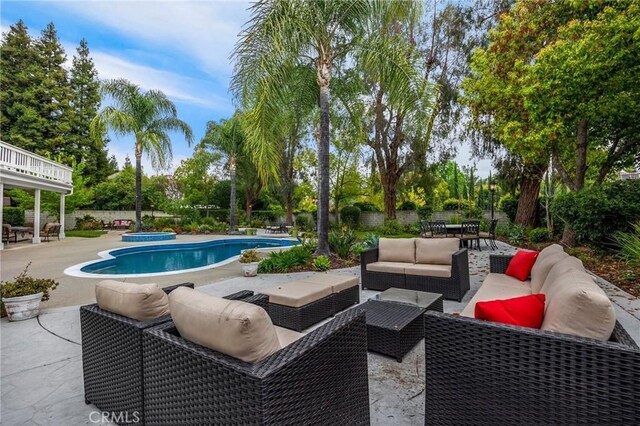pool with a patio, outdoor lounge area, and a fenced backyard
