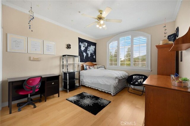 bedroom with light wood-type flooring, crown molding, and ceiling fan