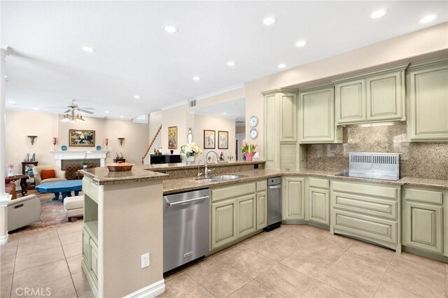 kitchen featuring a sink, green cabinetry, and stainless steel dishwasher