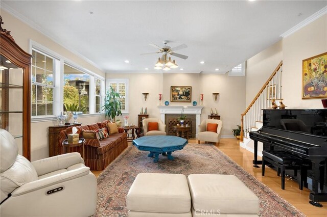 living room with stairs, recessed lighting, ceiling fan, and light wood-style floors