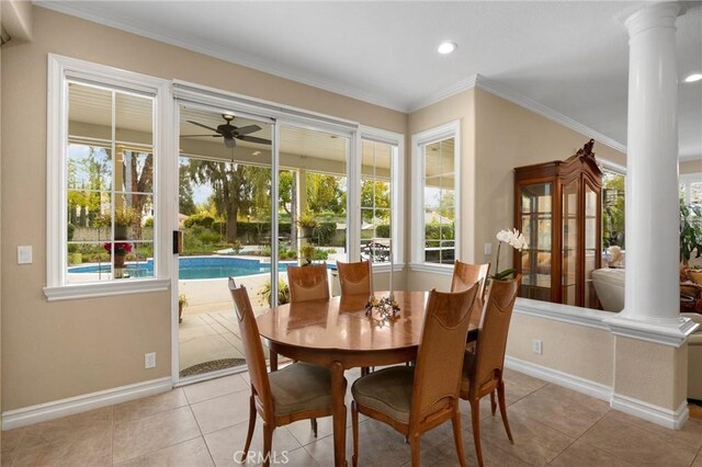 dining room with decorative columns, ceiling fan, and a healthy amount of sunlight