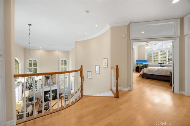 748 E Mariposa Dr, Redlands, CA 92373 - hallway with crown molding, light wood-style floors, recessed lighting, baseboards, and an upstairs landing
